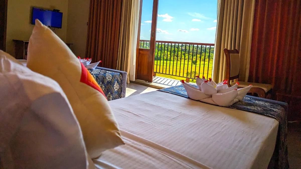 Sooriya Wessagiri Resort room with balcony view of green landscape in Anuradhapura